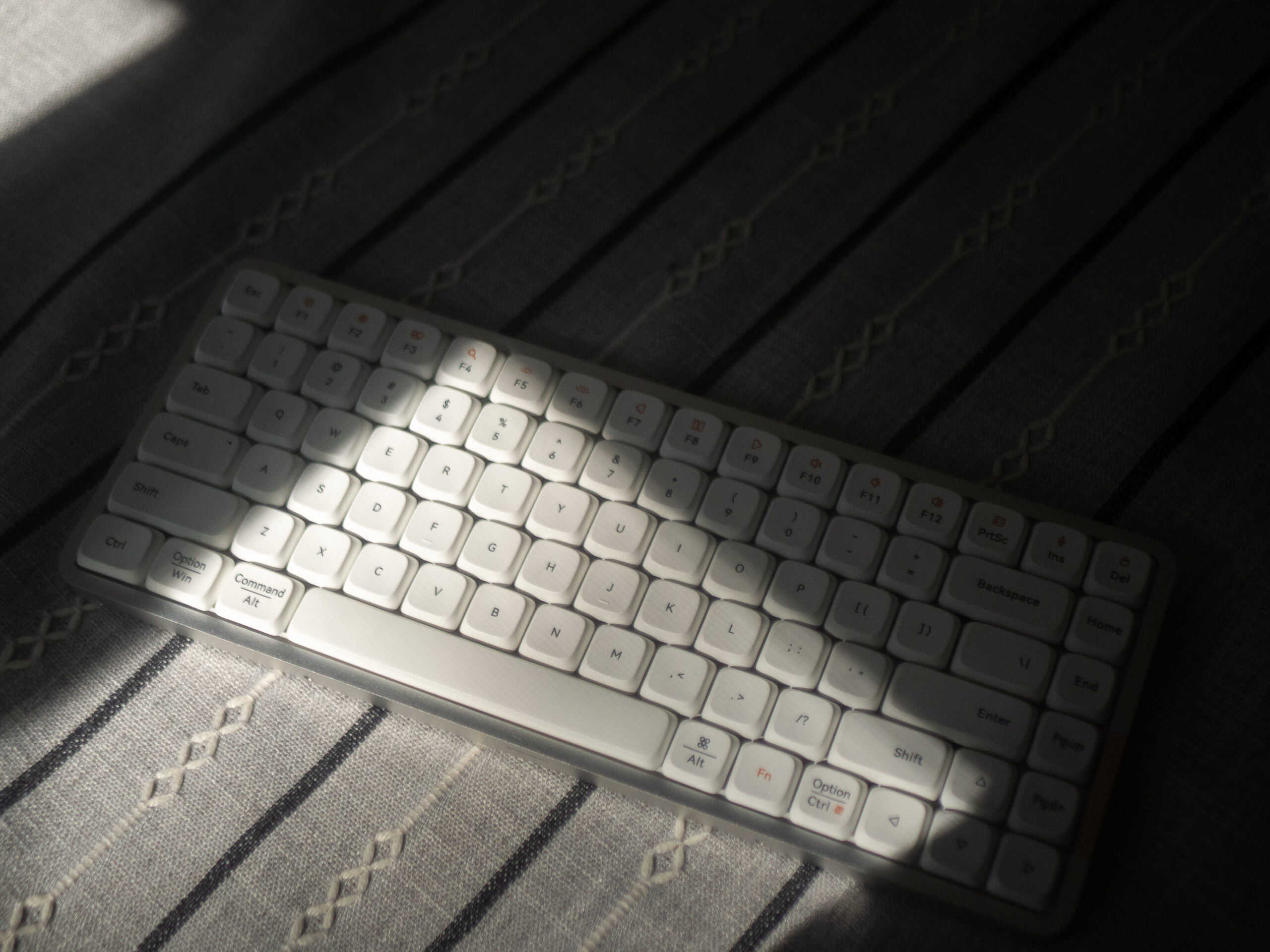 About A picture of a slime keyboard on a table in window light