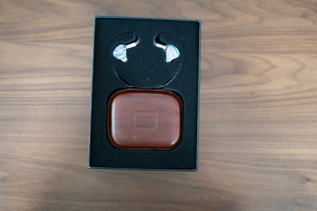 HiFiGo Juzear Defiant IEM earphones sitting on a table in their packaging