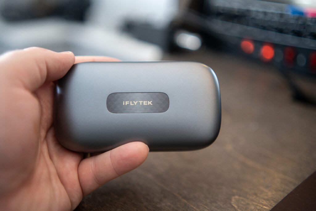 iFLYTEK AI Translation Earbuds battery case in someones hand