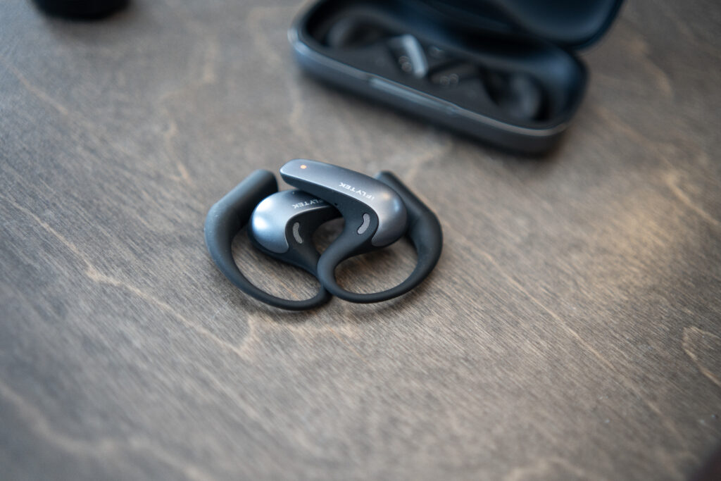 The iFLYTEK AI Translation Earbuds sitting on a desk