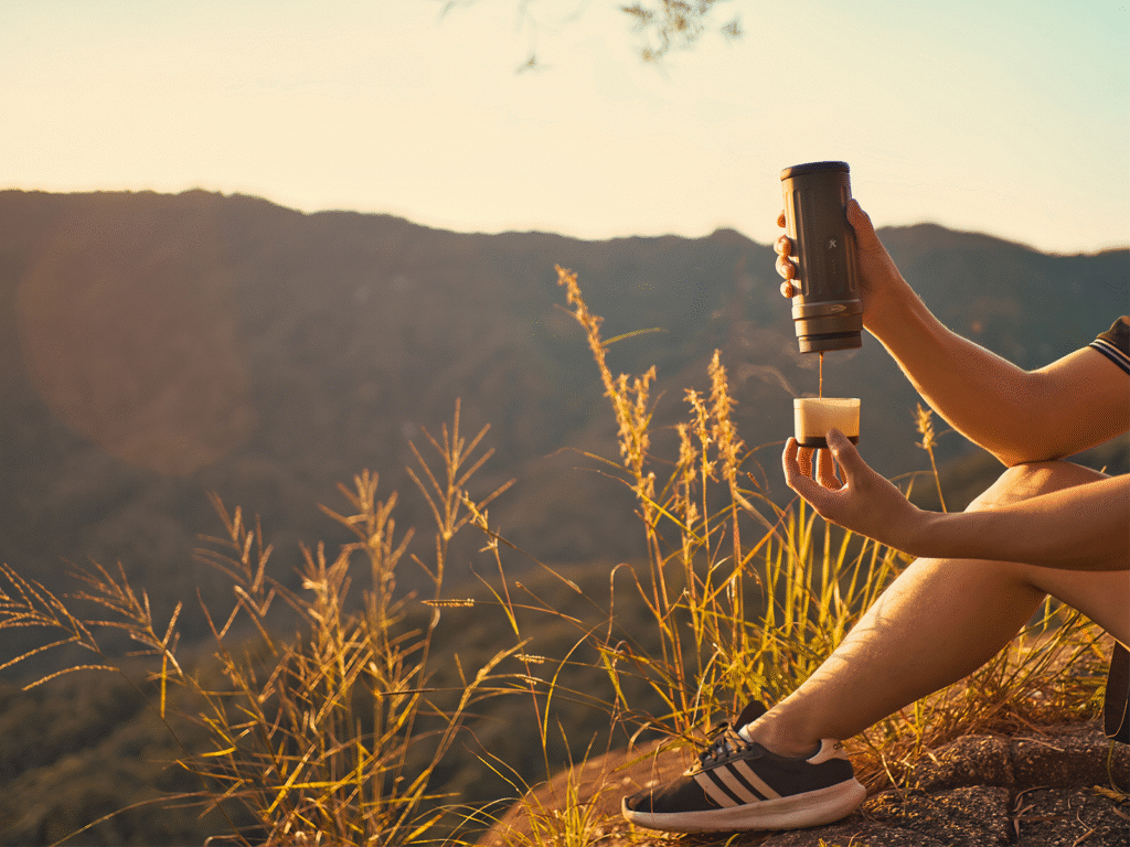 A person using a portable espresso machine on a hike